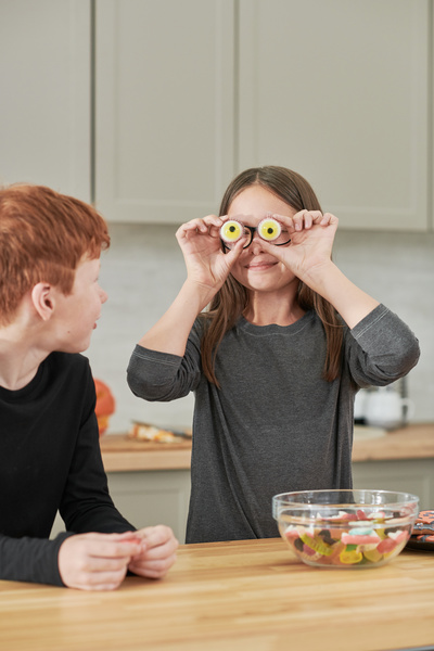 Brother and Sister Play with Halloween Marmalades in Shape of Eyes